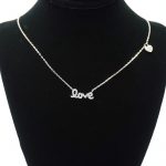 The Love Necklace in Silver on Stand